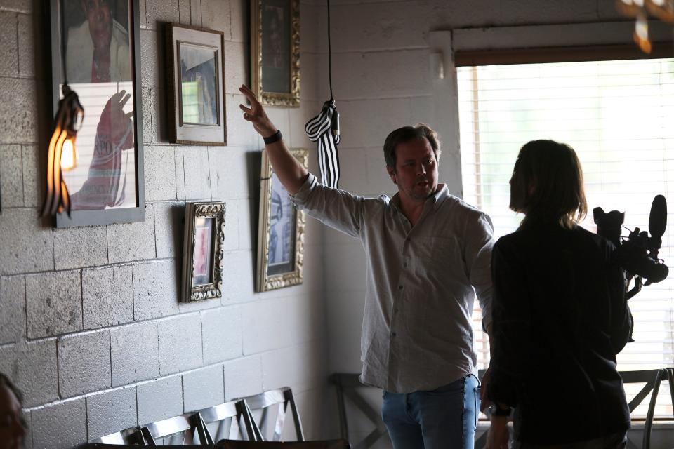 Director Matt Payne, left, points out pictures on the walls of Florence's Restaurant to camera operator Kevin Ford during filming of the upcoming documentary "The Jewel."