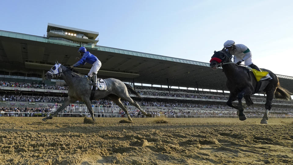 Jockey Luis Saez reacts after crossing the finish line ahead of Hot Rod Charlie (4), with jockey Flavien Prat up, to win the 153rd running of the Belmont Stakes horse race with Essential Quality (2),, Saturday, June 5, 2021, At Belmont Park in Elmont, N.Y. (AP Photo/Seth Wenig)