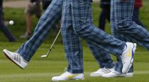 RNPS YEAR END 2014 - BEST OF SPORT ODDLY European Ryder Cup player Martin Kaymer (L) kicks his ball as he walks with teammates Rory McIlroy (C) and Sergio Garcia along the seventh fairway during practice ahead of the 2014 Ryder Cup at Gleneagles in Scotland in this September 23, 2014 file photo. REUTERS/Russell Cheyne/Files (BRITAIN - Tags: SPORT GOLF TPX IMAGES OF THE DAY)