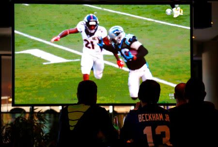 Australian NFL fans watch the telecast of the NFL Super Bowl on a large screen at the Western Suburbs Leagues Club in Leumeah, located west of Sydney, Australia, February 8, 2016. REUTERS/David Gray