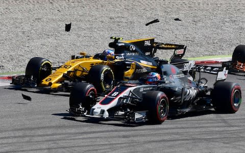 Car parts fly after the cars of Haas F1's French driver Romain Grosjean (R) and Red Bull's Dutch driver Max Verstappen (not pictured) crash during the Italian Formula One Grand Prix - Credit:  AFP