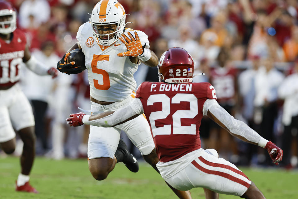 Tennessee wide receiver Bru McCoy (5) runs for a first down as he blocks a tackle from Oklahoma defensive back Peyton Bowen (22) during the half of an NCAA college football game, Saturday, Sept. 21, 2024, in Norman, Okla. (AP Photo/Alonzo Adams)