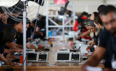 Brazilian electoral workers seal electronic ballot boxes in Brasilia, Brazil September 19, 2018. REUTERS/Adriano Machado