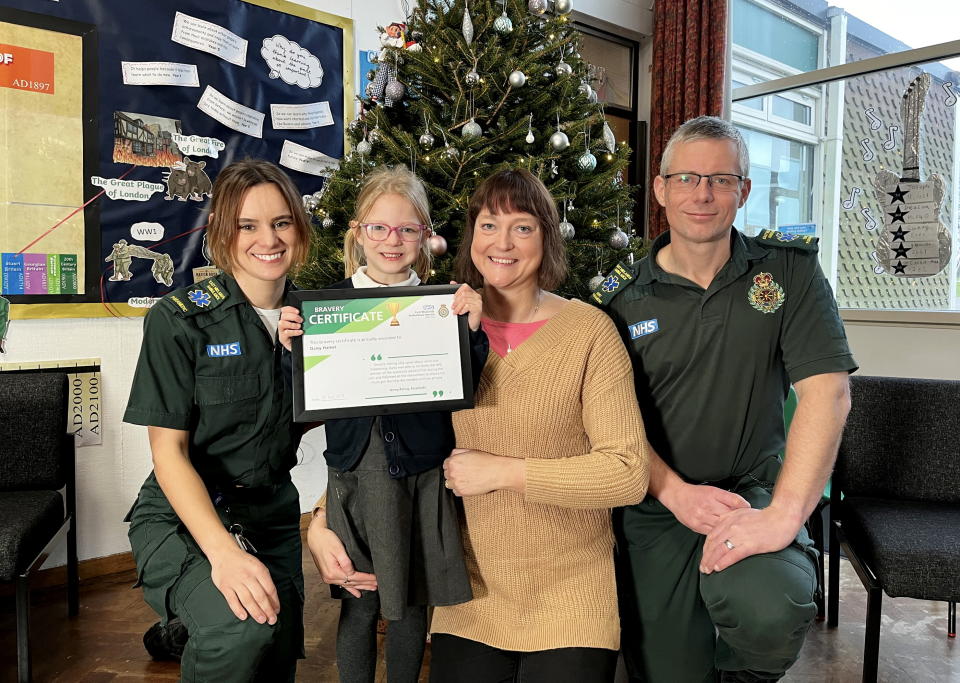 Daisy Hamer with mum Aimee and paramedics Phillip Rowe and Jenny Paling, who responded to Daisy's 999 call after her mum fell unconscious at home. (EMAS/SWNS)