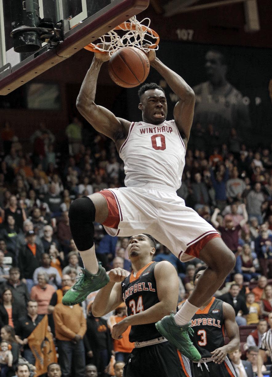 Winthrop's Duby Okeke (0) dunks past Campbell's Marcus Burk (34) in the first half of the Big South Conference championship NCAA college basketball game in Rock Hill, S.C., Sunday, March 5, 2017. (AP Photo/Chuck Burton)