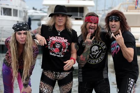 Steel Panther bandmates Michael Starr, Satchel, Lexxi Foxx and Stix Zadinia pose during a photocall for the "Steel Panther" television series project during the annual MIPCOM television programme market in Cannes, France, October 17, 2016. REUTERS/Eric Gaillard