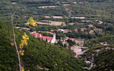 The Catholic Church of Shkrel, Albania, July 13, 2017, rises at the foot of a mountain near what was the ancestral home of former pharmaceuticals entrepreneur Martin Shkreli, who is vilified for raising the price of a life-saving drug by 5,000 percent and is now on trial for securities fraud in New York. Picture taken July 13, 2017. REUTERS/Benet Koleka