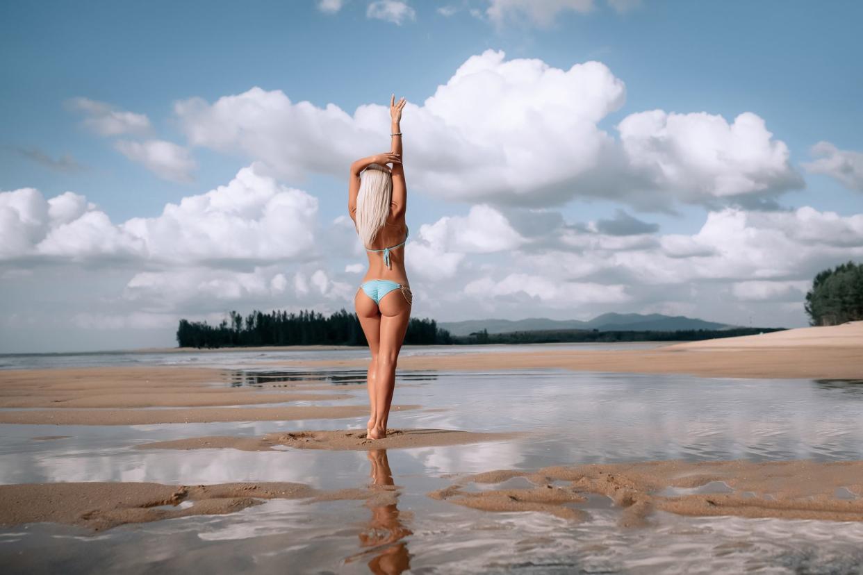 Woman-On-The-Beach-In-Bikini-Stock-Photo