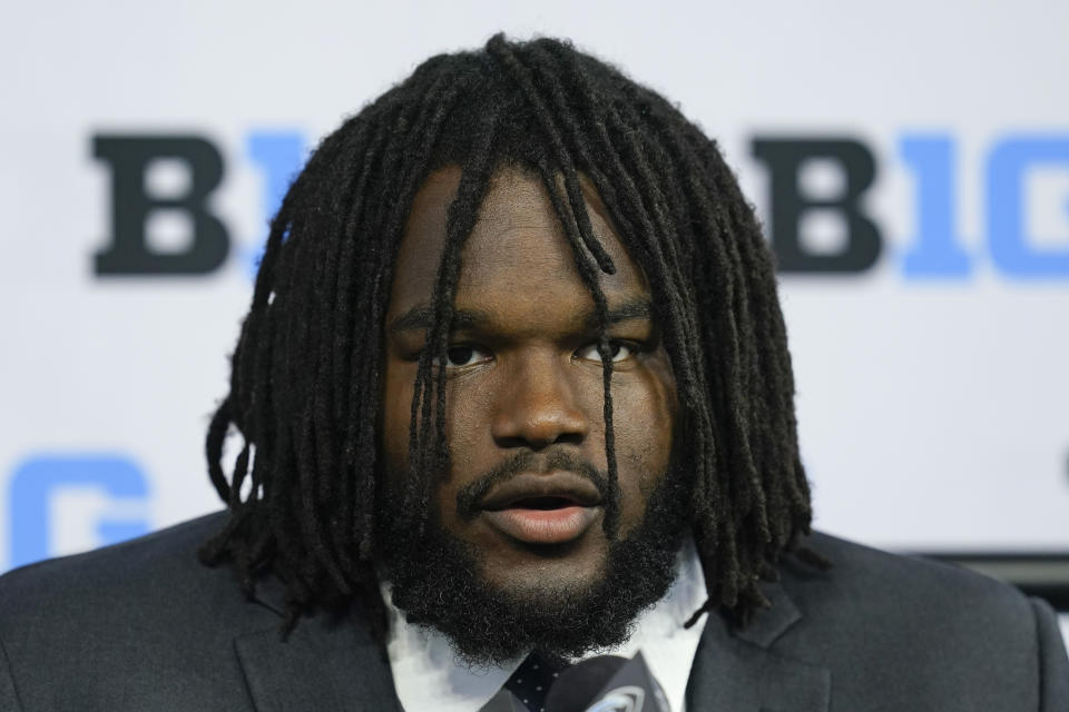 FILE - Michigan defensive tackle Mazi Smith talks to reporters during an NCAA college football news conference at the Big Ten Conference media days, at Lucas Oil Stadium, Tuesday, July 26, 2022, in Indianapolis. Michigan standout defensive lineman Mazi Smith has been charged with carrying a concealed weapon, records show. The felony charge was filed Wednesday, Nov. 30, 2022, in an Ann Arbor court, nearly two months after the alleged incident, according to online records. (AP Photo/Darron Cummings, File)