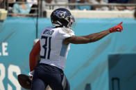 Tennessee Titans free safety Kevin Byard (31) celebrates after scooping up a Jacksonville Jaguars fumble and returning it 30-yars for a touchdown during the first half of an NFL football game, Sunday, Oct. 10, 2021, in Jacksonville, Fla. (AP Photo/Phelan M. Ebenhack)