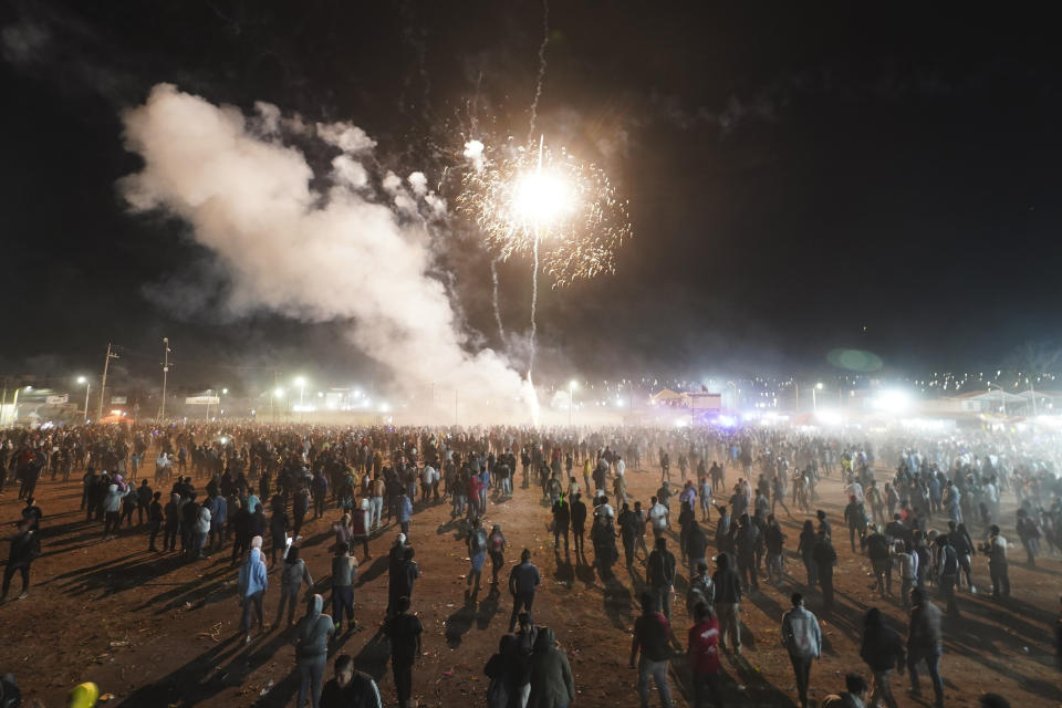 Residents attend the nighttime lighting of giant paper-mache "toritos" or bulls stuffed with fireworks during the annual festival honoring Saint John of God, in Tultepec, Mexico, Friday, March 8, 2024. The celebration, now its 35th year, pays homage to the patron saint of the poor and sick, St. John of God, who the fireworks' producers view as a protective figure. (AP Photo/Marco Ugarte)