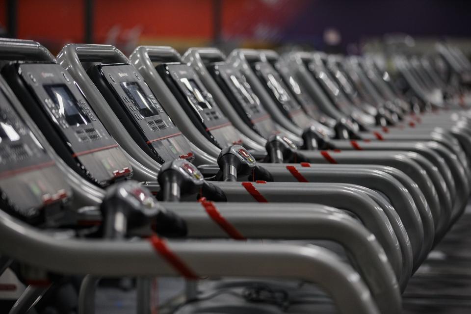 Dozens of treadmills are lined up in the cardio section of Crunch Fitness in Tallahassee, Fla.