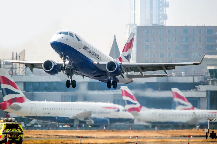 A plane taking off from an airport runway.