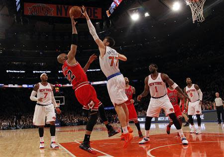 Dec 11, 2013; New York, NY, USA; Chicago Bulls power forward Taj Gibson (22) has his shot blocked by New York Knicks power forward Andrea Bargnani (77) in the first half of NBA game at Madison Square Garden. Noah K. Murray-USA TODAY Sports