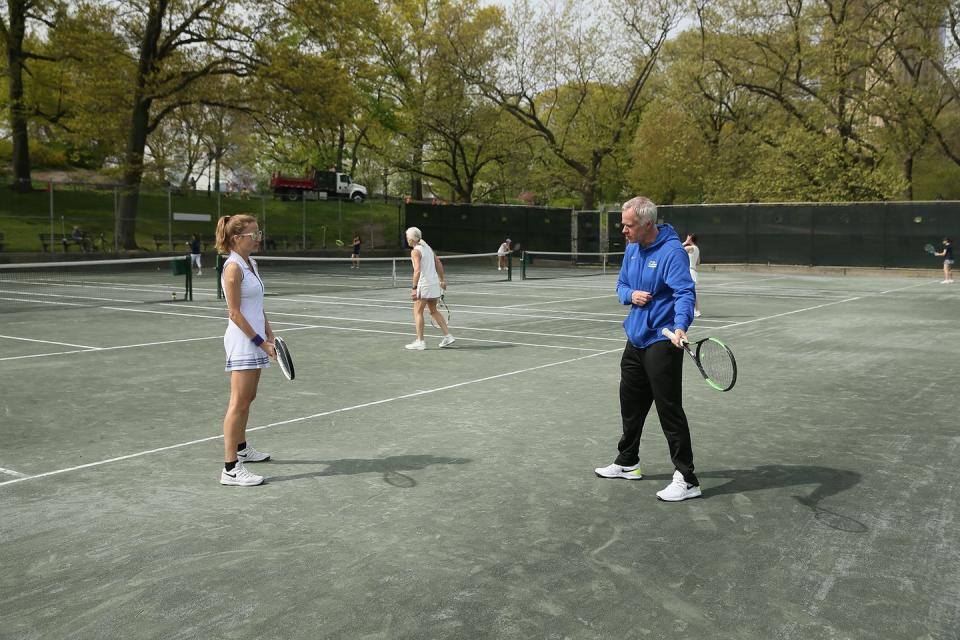 Patrick McEnroe coaching one of the players.