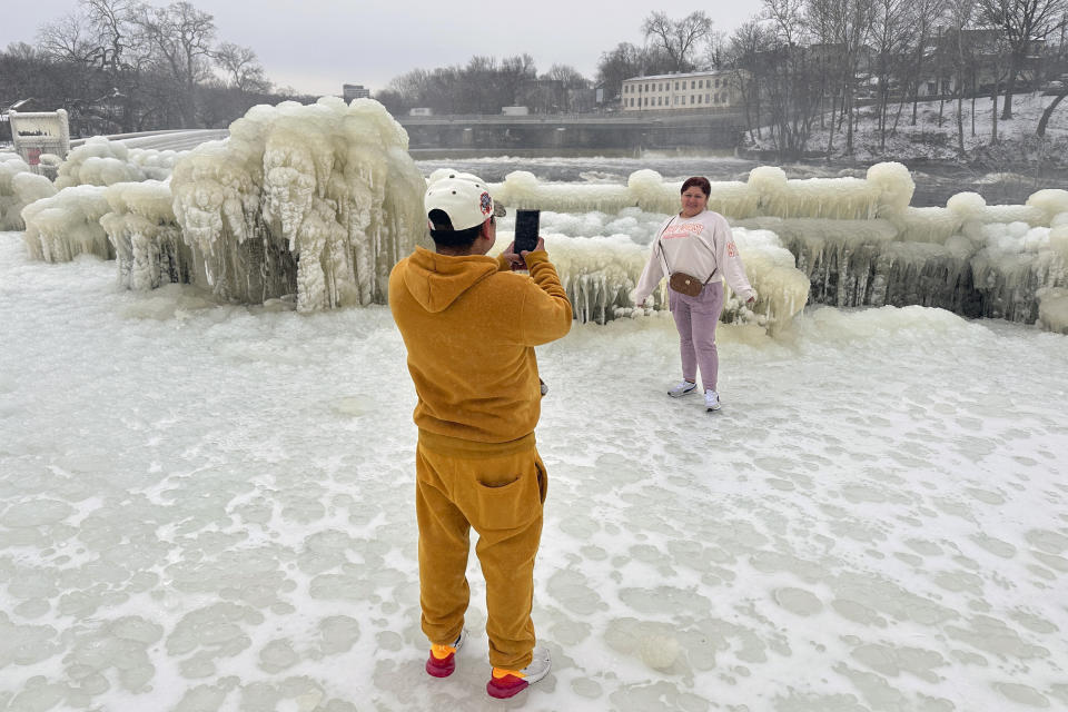 Mist from the Great Falls has created a frozen wonderland around the waterfalls in Paterson, N.J., on Thursday, Jan. 18, 2024. People are braving the subfreezing cold temps and slippery walkways to visit the ice-covered trees, benches and lamposts. (AP Photo/Ted Shaffrey)