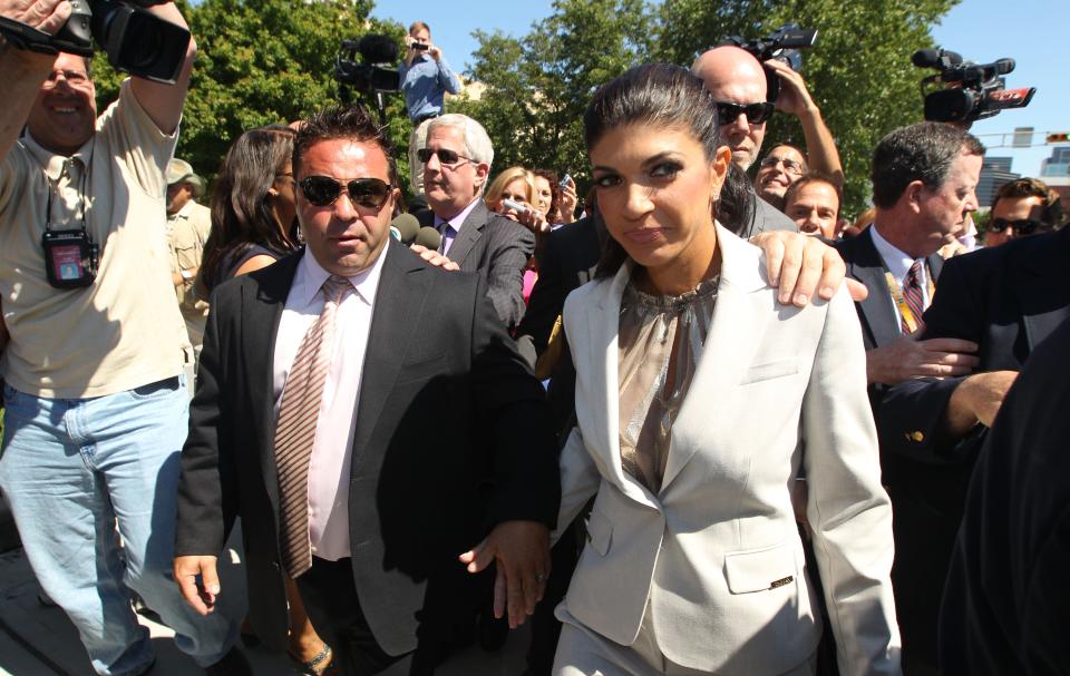 Teresa Giudice of "Real Housewives of New Jersey" fame and her husband Giuseppe "Joe" Giudice leave the Federal Courthouse in Newark on July 30, 2013, after being charged with conspiracy to commit mail and wire fraud, bank fraud, making false statements on loan applications and bankruptcy fraud.