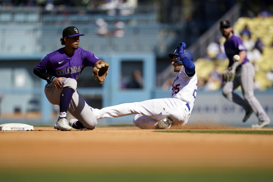 Los Angeles Dodgers' Trayce Thompson, front right, steals second base past Colorado Rockies shortstop Ezequiel Tovar, left, during the fifth inning of a baseball game Sunday, Oct. 2, 2022, in Los Angeles. (AP Photo/Marcio Jose Sanchez)