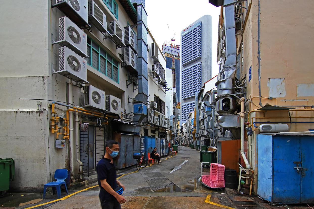 SINGAPORE - NOVEMBER 24: A man wearing protective face mask walks along a back alley of a popular tourist dining spot at Boat Quay on November 24, 2020 in Singapore. As of November 23, the Ministry of Health confirmed five new imported COVID-19 cases bringing the country's total to 58,165. For the 13th straight day, there are no new cases of locally transmitted infection. (Photo by Suhaimi Abdullah/Getty Images)