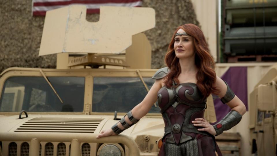 Domonique McElligott as Queen Maeve in The Boys stands in front of beige military truck in her superhero outfit