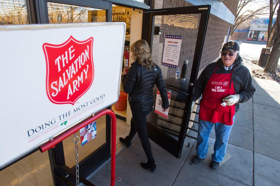 In this file photo, Salvation Army bell ringer Robert Thompson wishes a customer a merry Christmas as he holds the door open on Dec. 21, 2018, in front of the Hobby Lobby on South College Avenue in Fort Collins. Thompson, who died in 2023, was a longtime bell ringer for The Salvation Army, and his kettle netted the Krugerrand coin multiple times.