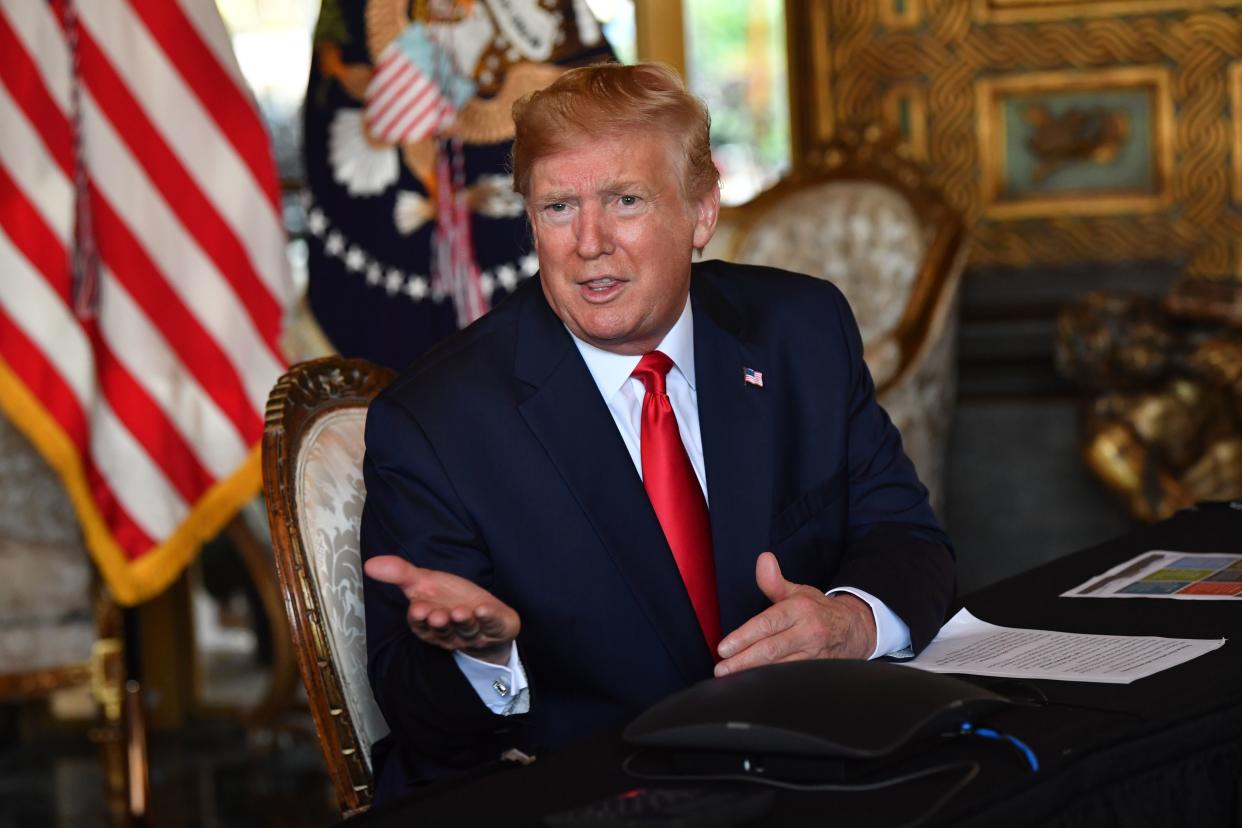 US President Donald Trump answers questions from reporters after making a video call to the troops stationed worldwide at the Mar-a-Lago estate in Palm Beach Florida, on December 24, 2019. (Nicholas Kamm/AFP via Getty Images)