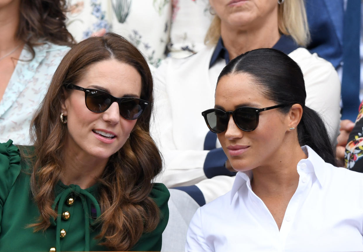 Catherine, Duchess of Cambridge and Meghan, Duchess of Sussex in the Royal Box on Centre Court during day twelve of the Wimbledon Tennis Championships at All England Lawn Tennis and Croquet Club on July 13, 2019 in London, England. (Photo by Karwai Tang/Getty Images)