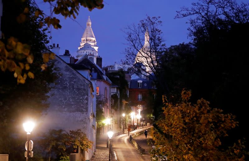 FILE PHOTO: A street is seen in Montmartre few minutes before the nightly curfew due to restrictions against the spread of the coronavirus disease (COVID-19) in Paris