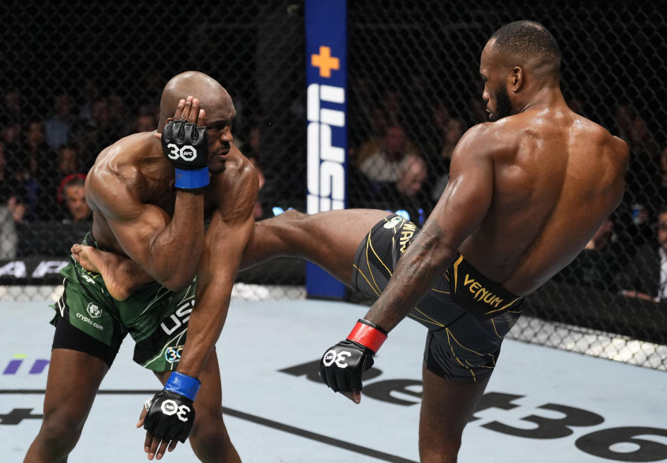 LONDON, ENGLAND - MARCH 18: (R-L) Leon Edwards of Jamaica kicks Kamaru Usman of Nigeria in a lightweight fight during the UFC 286 event at The O2 Arena on March 18, 2023 in London, England. (Photo by Jeff Bottari/Zuffa LLC via Getty Images)