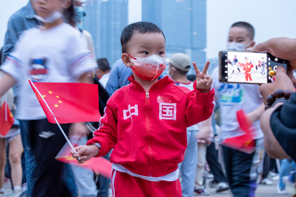 A child poses for a photo at Tianfu Square during a flag-raising ceremony in celebration of the 73rd anniversary of the founding of the People's Republic of China, in Chengdu, Sichuan, Oct. 1, 2022.<span class="copyright">Wu Ke—VCG/Getty Images</span>