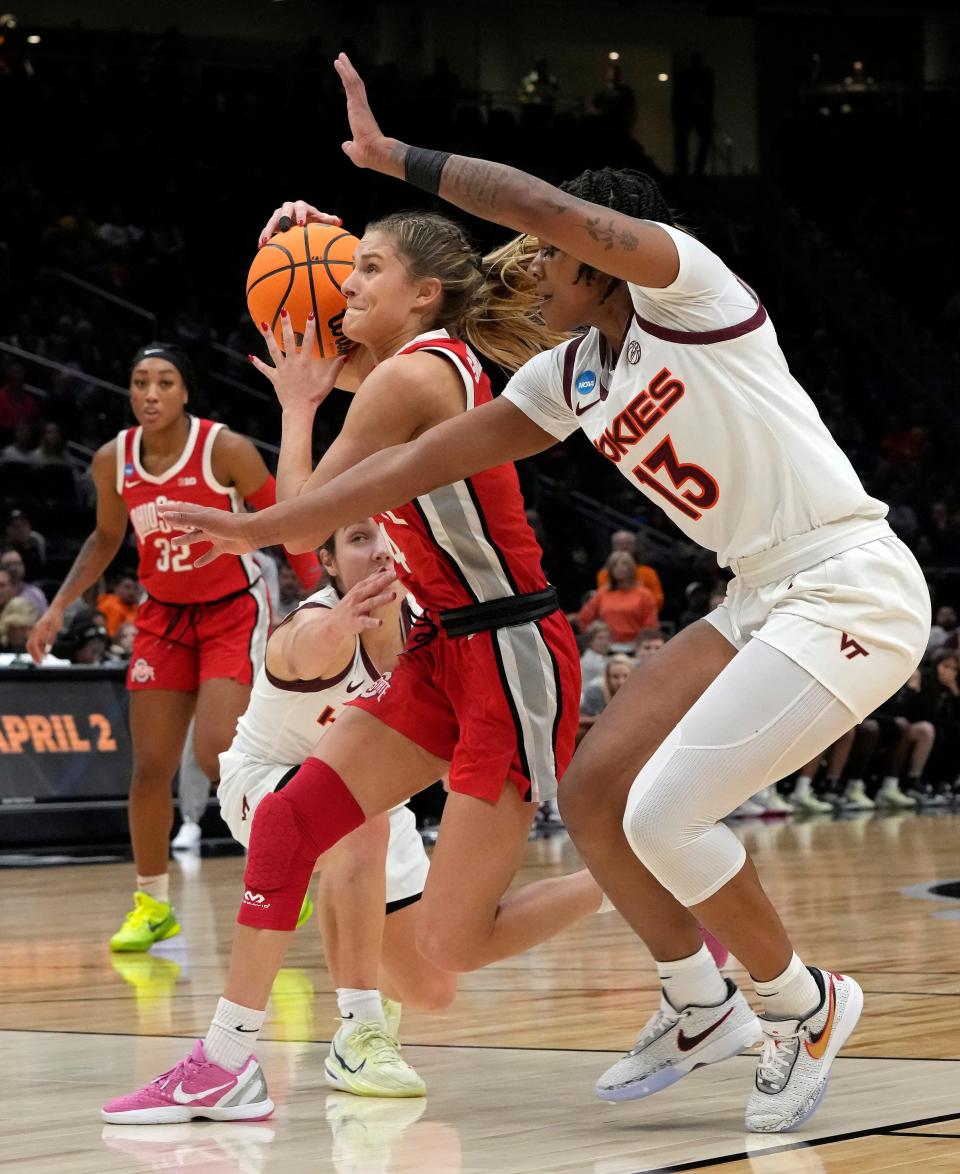 March 27, 2023; Seattle, WA, USA; Ohio State Buckeyes guard Jacy Sheldon (4) is guarded by Virginia Tech Hokies guard Georgia Amoore (5) and Virginia Tech Hokies forward Taylor Soule (13) during the second half of an NCAA Tournament Elite Eight basketball game at Climate Pledge Arena in Seattle on Monday. Mandatory Credit: Barbara J. Perenic/Columbus Dispatch