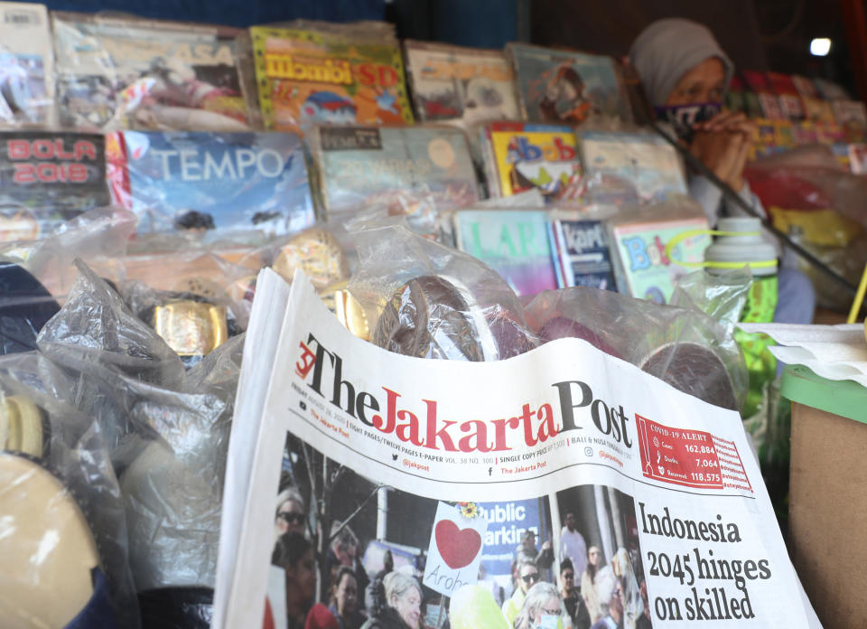 Copies of newspaper the Jakarta post are pictured at a news stand in Jakarta, Indonesia, Friday, Aug. 28, 2020. Indonesia’s leading English-language newspaper, The Jakarta Post, is considering laying off its staff as it struggles with the pandemic, a spokesperson for the publication's owner said Friday. (AP Photo/Achmad Ibrahim)