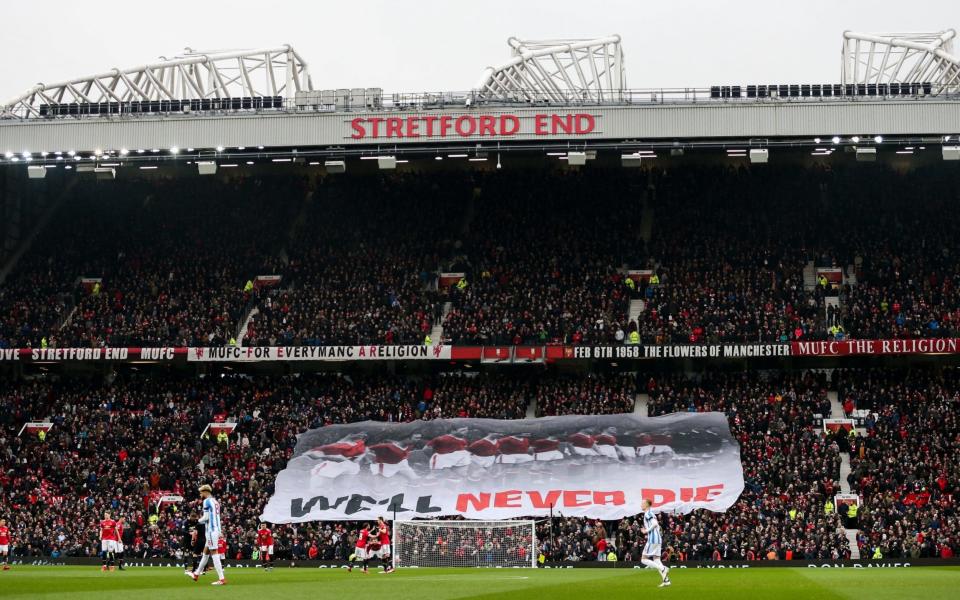 Fans in the Stretford End hold up a banner in respect of the Munich air disaster - Getty Images Europe