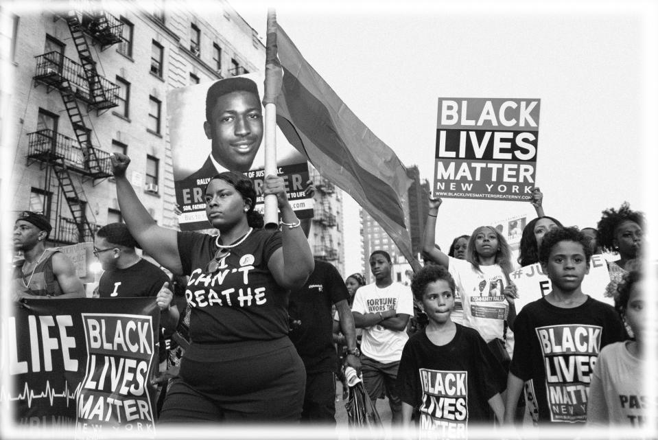 Activists with Black Lives Matter protest in the Harlem neighborhood of New York, Tuesday, July 16, 2019, in the wake of a decision by federal prosecutors who declined to bring civil rights charges against New York City police Officer Daniel Pantaleo, in the 2014 chokehold death of Eric Garner.  (Photo: Craig Ruttle/AP; digitally enhanced by Yahoo News)