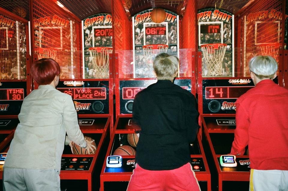 J-Hope, RM, and Suga shoot hoops.