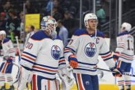 Edmonton Oilers goaltender Calvin Pickard (30) and center Connor McDavid, front right, warm up before a preseason NHL hockey game against the Seattle Kraken, Monday, Oct. 2, 2023, in Seattle. (AP Photo/Jason Redmond)