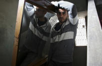 In this April 21, 2019 photo, Palestinian groom Yehiya Taleb, center, move a mirror, part of his wedding furniture, to his apartment in Shati refugee camp, Gaza City. Hundreds of young men in the Gaza Strip have turned to a small industry of lenders to help them pay for their weddings. Taleb got a job working as a waiter at a cafe earning about $180 a month, but that amount was not enough to cover wedding expenses so he took out a $2,000 package through the Farha Project, one of the wedding financing companies. (AP Photo/Adel Hana)