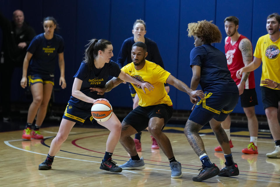 Indiana Fever guard Caitlin Clark, front left, makes a play against the practice squad as the WNBA basketball team works out in Indianapolis, Sunday, April 28, 2024. (AP Photo/Michael Conroy)