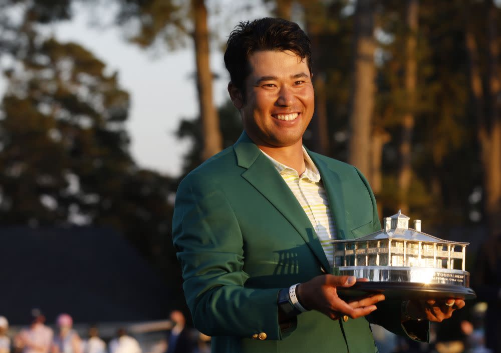 Japan's Hideki Matsuyama celebrates with the green jacket and the trophy after winning The Masters at the Augusta National Golf Club April 11, 2021. — Reuters pic