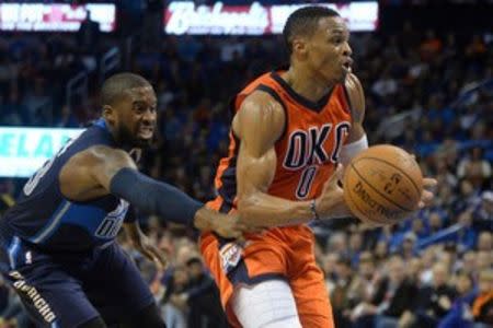 Oklahoma City Thunder guard Russell Westbrook (0) drives to the basket in front of Dallas Mavericks guard Wesley Matthews (23) during the fourth quarter at Chesapeake Energy Arena. Mandatory Credit: Mark D. Smith-USA TODAY Sports