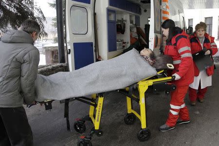 Medics transport a woman, who according to locals was injured by recent shelling, at a hospital in Donetsk, eastern Ukraine, January 26, 2015. REUTERS/Alexander Ermochenko