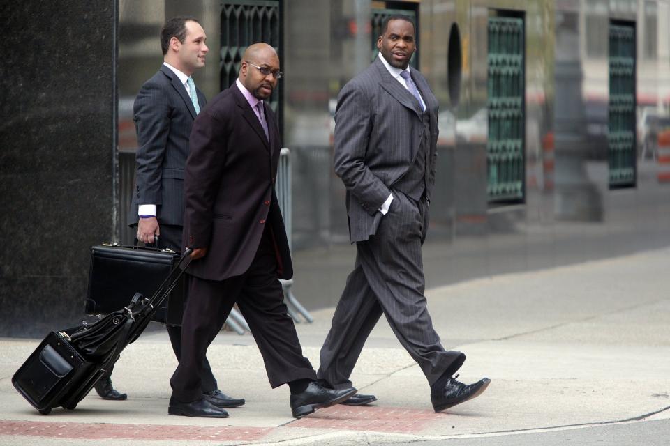 Right, former Detroit Mayor Kwame Kilpatrick and his co-defendant Bobby Ferguson, center, leave the Theodore Levin United States Courthouse in Detroit in 2012.