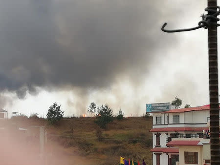 Smoke rises following the crash of a Bangladeshi aircraft at Kathmandu airport, Nepal March 12, 2018 in this picture obtained from social media. RUSHA GIRI/via REUTERS