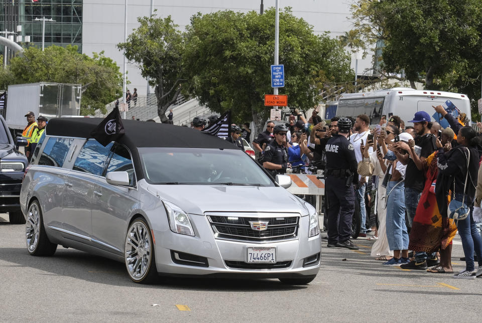 The hearse carrying rapper Nipsey Hussle leaves the Staples Center after a memorial service in Los Angeles, Thursday, April 11, 2019. Hussle was killed in a shooting outside his Marathon Clothing store in south Los Angeles on March 31. (AP Photo/Ringo H.W. Chiu)