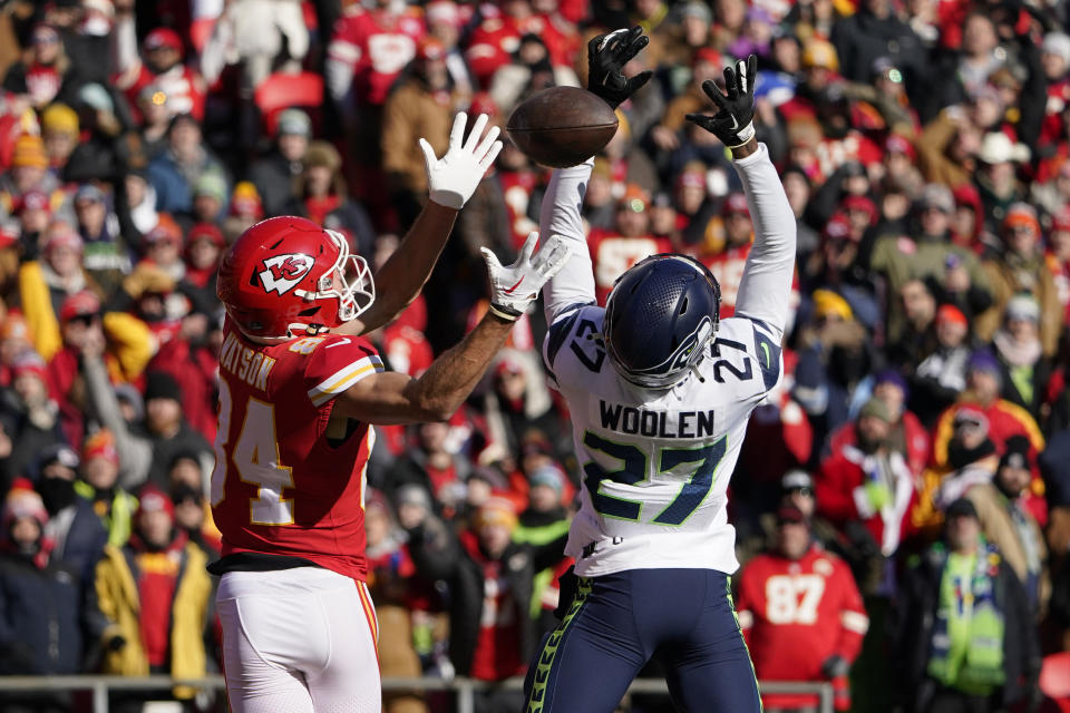 Kansas City Chiefs wide receiver Justin Watson (84) is unable to catch a pass as Seattle Seahawks cornerback Tariq Woolen (27) defends during the first half of an NFL football game Saturday, Dec. 24, 2022, in Kansas City, Mo. (AP Photo/Ed Zurga)