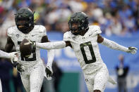 Oregon cornerback DJ James (0) celebrates after intercepting a pass during the first half of an NCAA college football game against UCLA, Saturday, Oct. 23, 2021, in Pasadena, Calif. (AP Photo/Marcio Jose Sanchez)