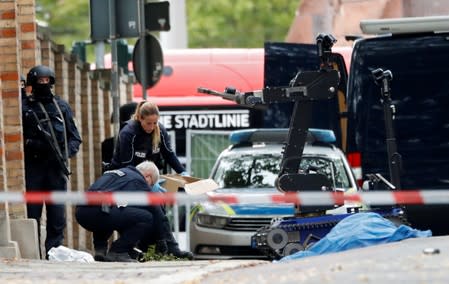 Police officers work at the site of a shooting in Halle