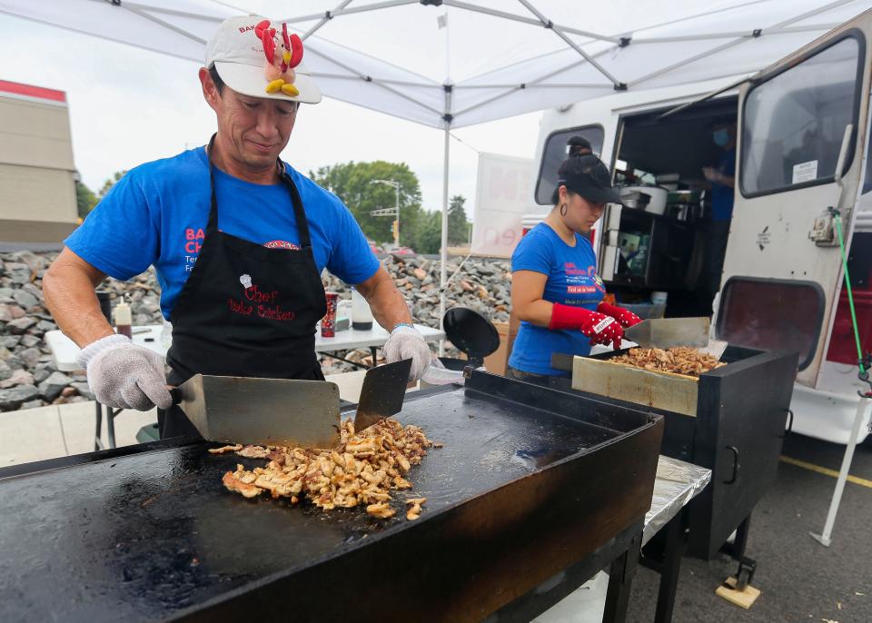 TJ Jones cooks a batch of chicken for the Baka Chicken food truck on Aug. 6 at Forward Bank in Marshfield.