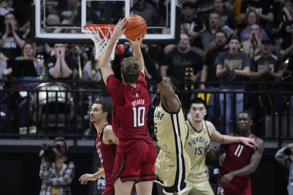 Rutgers guard Cam Spencer (10) hit a basket to take the lead over Purdue guard Brandon Newman (5) in the closing seconds of the second half of an NCAA college basketball game in West Lafayette, Ind., Monday, Jan. 2, 2023. Rutgers defeated Purdue 65-64. (AP Photo/Michael Conroy)