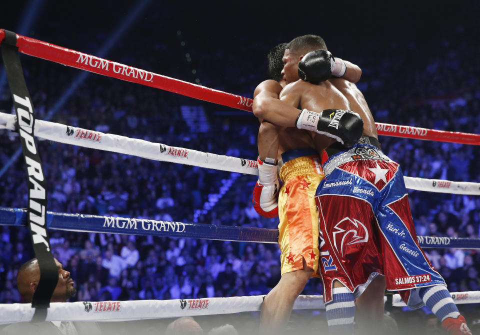 Yuriorkis Gamboa, from Miami, Fla., right, and Michael Farenas, from the Philippines, fall into a clinch against the ropes during their WBA interim super featherweight title fight Saturday, Dec. 8, 2012, in Las Vegas. (AP Photo/Eric Jamison)